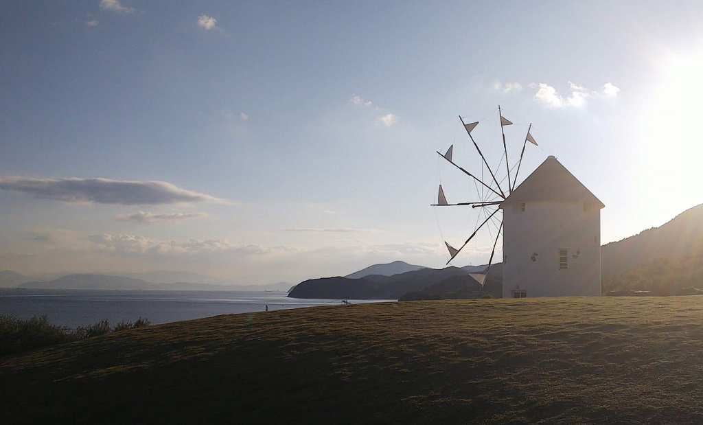 A view of Shodoshima's Greek Windmill, late afternoon (so it's a little backlit) with the Seto Inland Sea and Mito Peninsula in the background